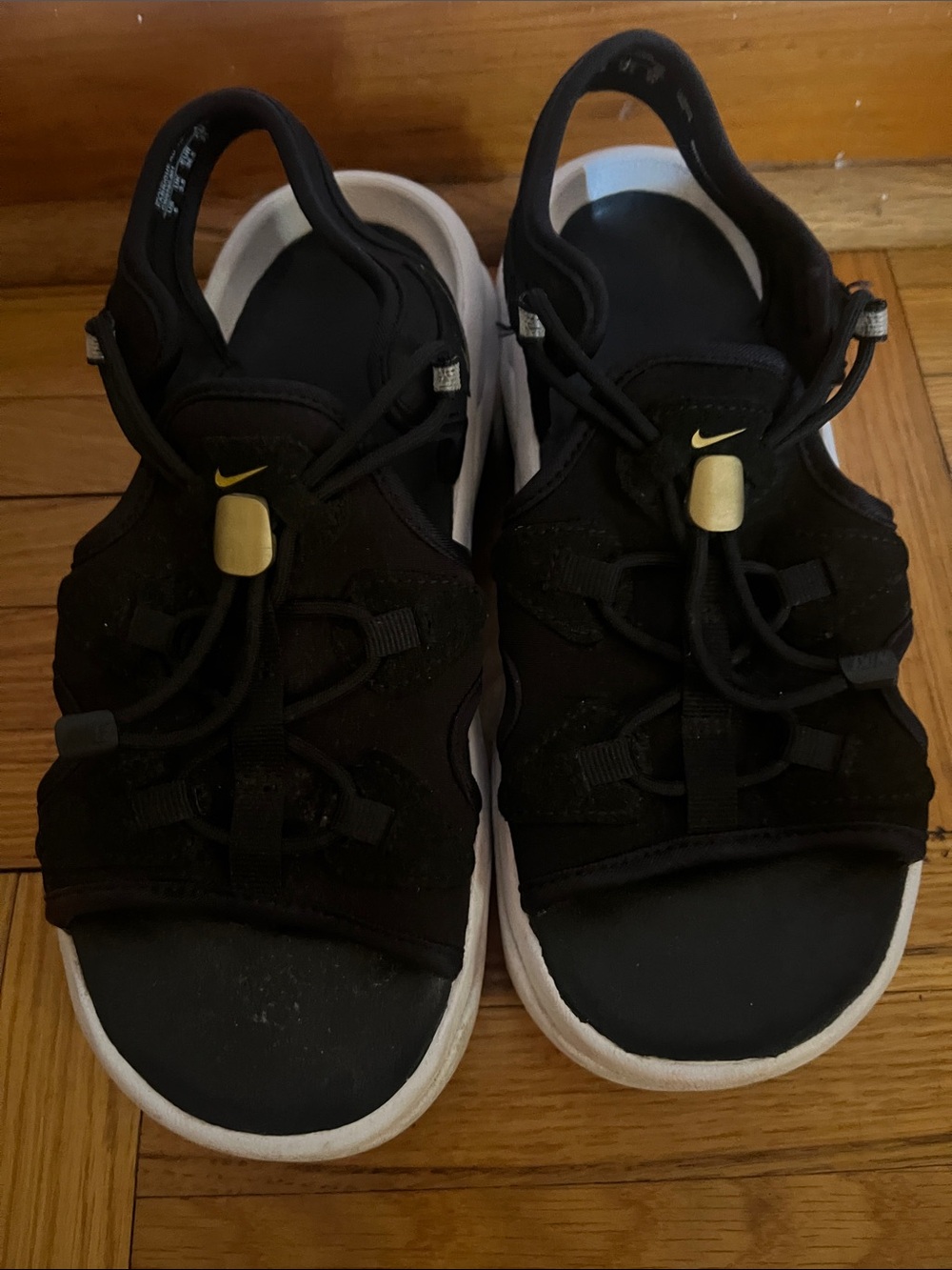Nike Black woman’s Sport Sandals with White Soles and Gold Accents